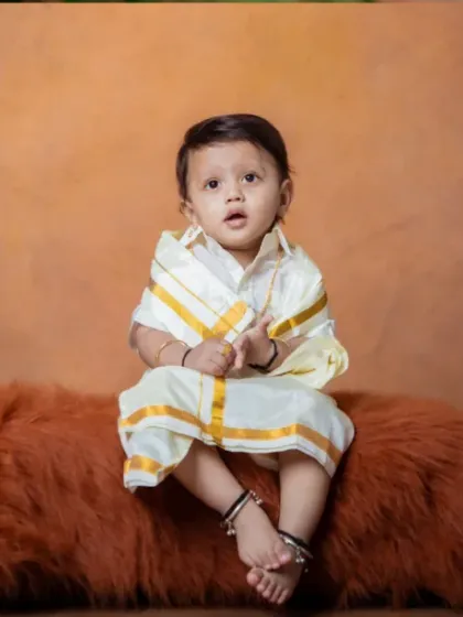 A tiny prince in traditional vibes, ready to rule the world with his cuteness.