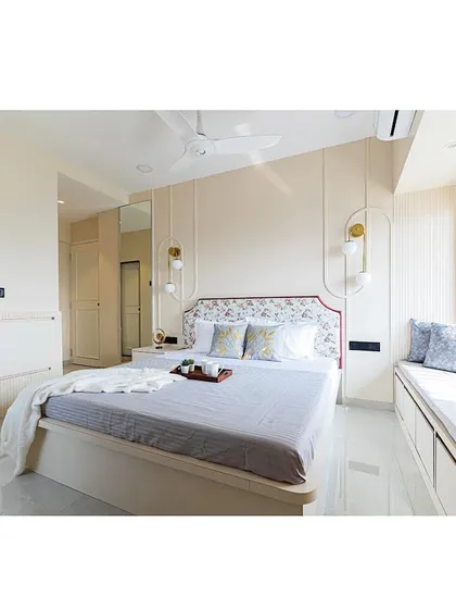 A serene and minimal bedroom design for a grandmother's room. The color palette is soft and neutral, with a floral headboard adding a touch of traditional charm.