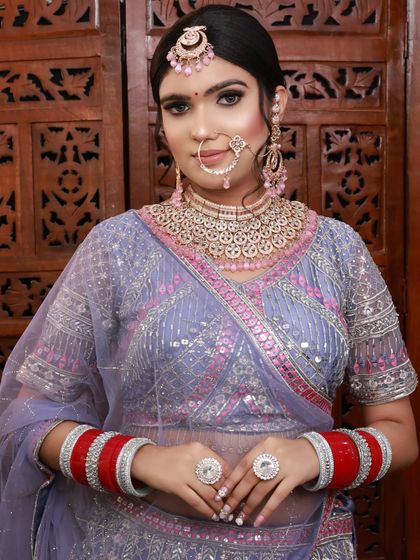 A full look of the bride in the lavender lehenga. The soft color of the outfit is paired with a glamorous makeup look.