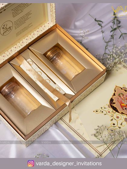 This Upanayanam invitation box combines the invitation card with thoughtful gifts. The elegant cream and gold box features compartments for jars, making it a luxurious and memorable way to invite guests to a sacred ceremony.