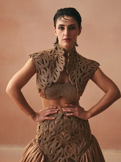 From my 'Cord Memory' collection, this ensemble is a testament to texture. I handcrafted the corded zari jacket and placement embroidery on the skirt to feel like inherited bonds made tangible. The design merges a satin bralette with a voluminous skirt, creating a silhouette that is both fierce and feminine.