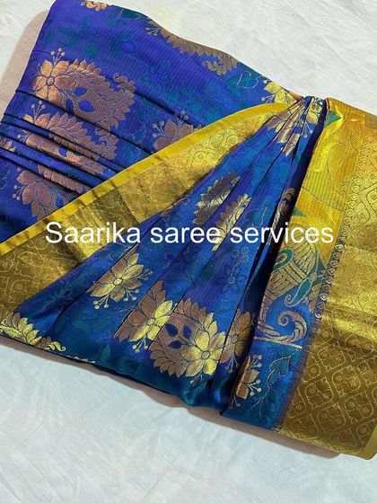 This blue and yellow Kanjivaram saree is a work of art. My service ensures it's perfectly prepared for you to wear.