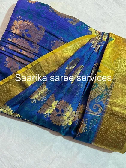 A stunning blue and yellow silk saree, folded to highlight its vibrant contrast.