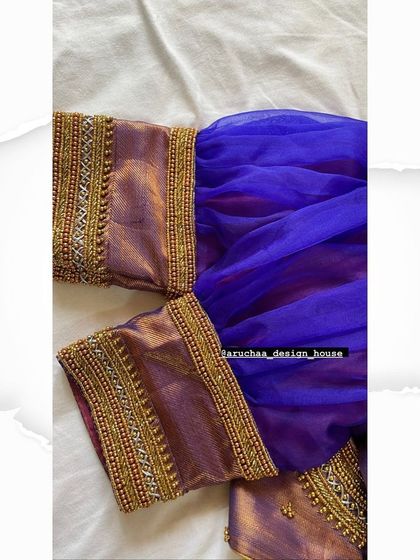 A custom blouse with elegant puffed sleeves in a sheer blue fabric, contrasted with a traditional brocade border featuring beadwork.