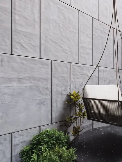 A minimalist detail shot focusing on a hanging swing chair against a tiled marble wall. This render is a study in texture, light, and shadow, demonstrating how even small vignettes can powerfully communicate a project's design intent.