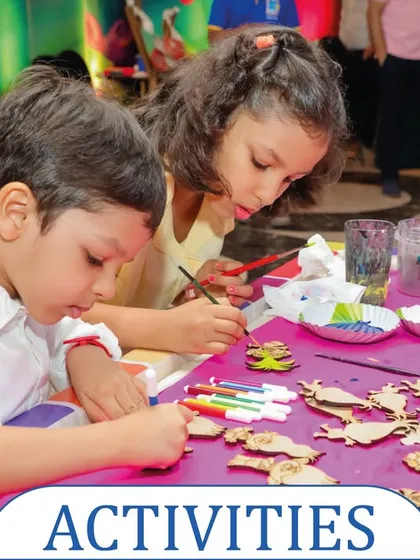 A wide shot of the DIY magnet painting table, where kids are busy coloring various wooden shapes. It's a perfect activity for keeping many children engaged at once.