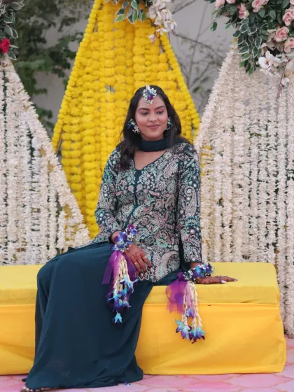 The bride is all smiles, ready for her Haldi. The makeup is minimal and fresh, with a focus on glowing skin and beautifully adorned hair.