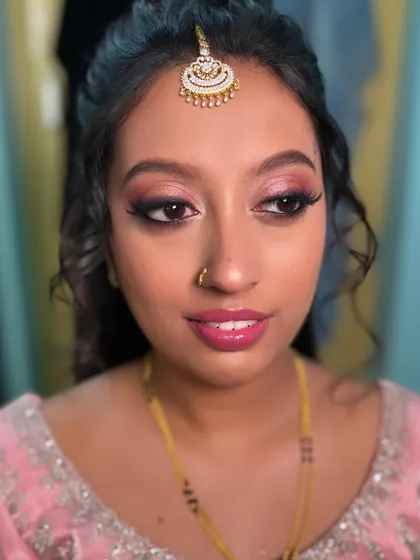 Nasreen's reception look from another angle. The pink tones in her makeup beautifully complement her skin tone and outfit.