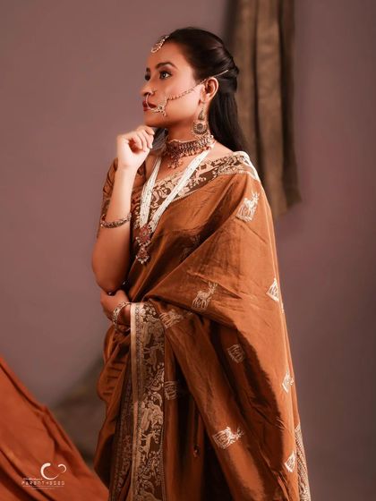 A classic three-quarter pose that showcases the beautiful drape of the saree. Her expression is serene and timeless.