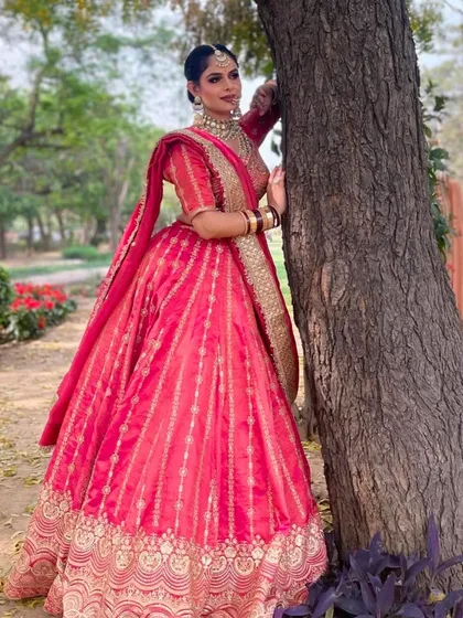 A beautiful outdoor shoot with our rani pink lehenga. The natural light brings out the richness of the color, making it ideal for a day wedding portfolio.