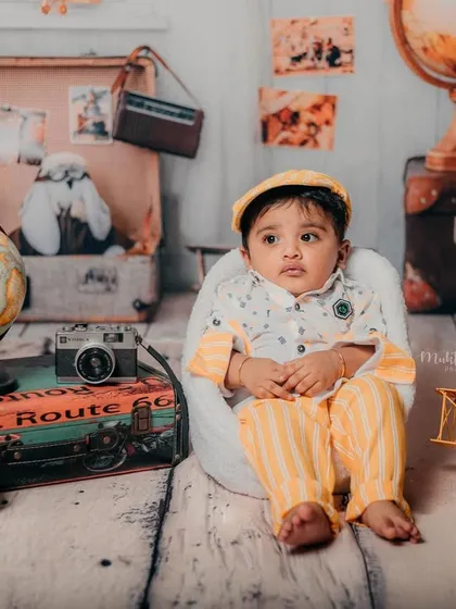 This tiny traveler is ready for big adventures. The yellow outfit and matching hat are perfect for this explorer theme.