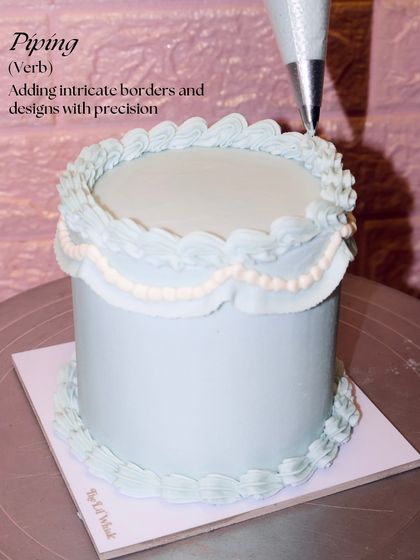 Next step: Piping. Here, we're adding intricate borders and delicate swag details with precision to create that signature vintage look.