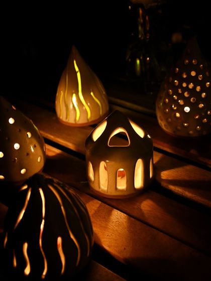 Handcrafted ceramic luminaries from the 'Moments Together' collection, designed to cast a warm, intimate glow for evening gatherings.