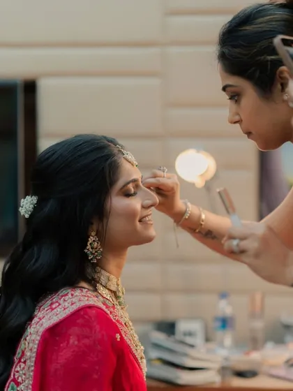 This candid photo captures me working on the bride's eye makeup, showing the focus and precision involved.