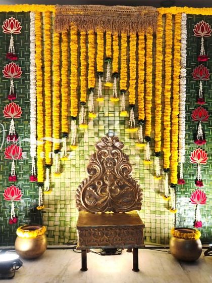 This traditional backdrop for a half saree ceremony is made from coconut leaves and marigold garlands. We added hanging lotus motifs and an antique-style throne to complete the authentic look.
