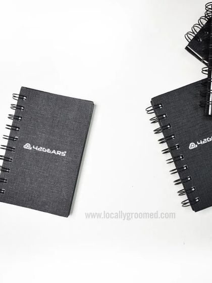 A stack of custom spiral notebooks we produced for 42Gears. We can handle bulk orders for stationery, ensuring consistent quality across every single item.