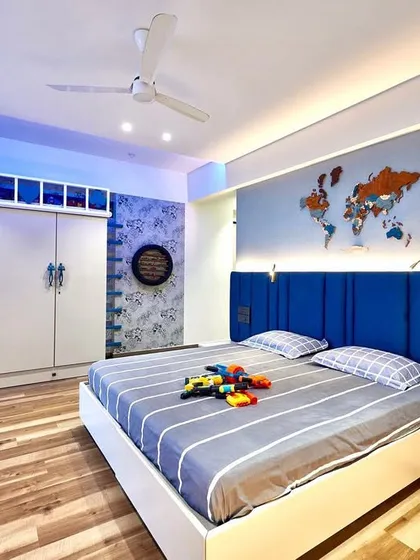 We also design vibrant and functional spaces for younger family members. This kid's bedroom features a world map decal, fun shelving, and cool blue accent lighting to create a playful and inspiring environment.