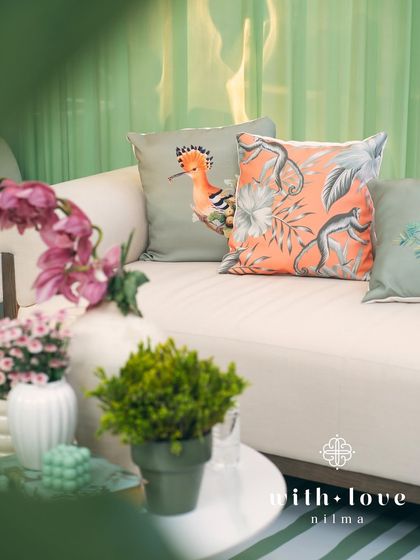 A close-up of the custom cushions in 'The Conservatory', featuring whimsical bird and monkey prints.
