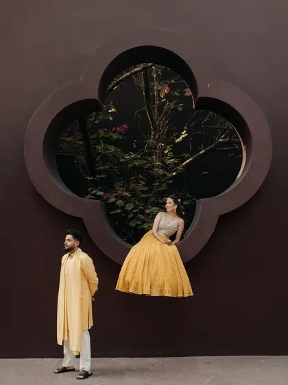 A creative and artistic pre-wedding portrait that plays with architecture and perspective. We love finding unique frames within a location to tell a story, making the couple's portrait feel like a piece of art.