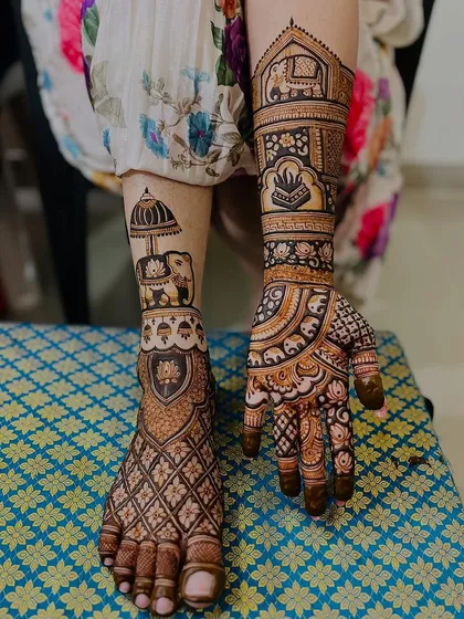 This design shows how hand and foot mehndi can tell a story together. The foot features an elephant with a royal umbrella, which complements the traditional motifs on the hand.