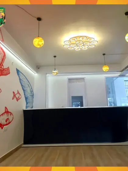 A look at the clean and modern counter of Cafe Smurf, with fun, fish-themed wall art adding to the playful ambiance.