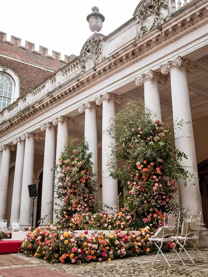 The floral-adorned mandap at Hampton Court Palace, a perfect example of how we blend romantic decor with historic architecture.