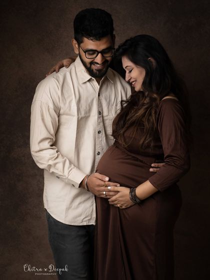 A candid and loving portrait. The genuine smiles and gentle touch make this photo feel incredibly warm and authentic.