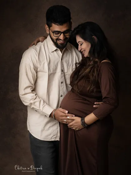 A candid and loving portrait. The genuine smiles and gentle touch make this photo feel incredibly warm and authentic.