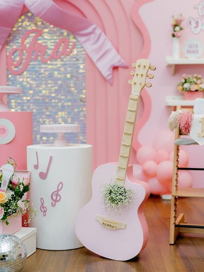 A close-up of the pink guitar prop, adorned with flowers, adding a sweet and stylish touch to the dance party.