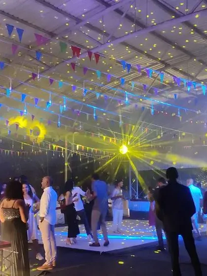 A wide shot of the party in full swing, showing the dynamic lighting and energetic atmosphere we can create for your corporate event.