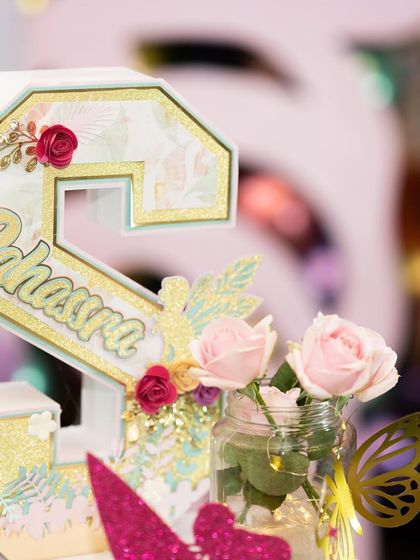 A closer look at the custom initial decor for Sahasra's party. The combination of florals, glitter, and a fairy silhouette made this a truly personalized and magical element.