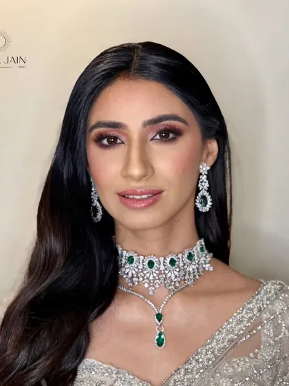 A close-up showing the flawless makeup and the simple elegance of the hairstyle.