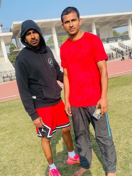 Posing with a fellow athlete at the stadium. We are a community of individuals who share a passion for running and fitness.