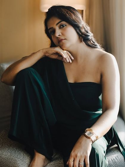 A relaxed portrait showcasing the versatility of the look. This jumpsuit can easily transition from a day event to an evening function, making it a valuable addition to a professional's wardrobe.