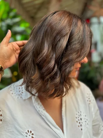 A side view of the 'Brown Sugar' bob. The subtle highlights add dimension and texture to the short, chic cut.
