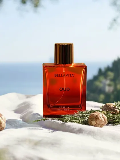 A lifestyle product shoot for a perfume brand, set against a natural, scenic backdrop to evoke a feeling of luxury and escape, connecting the product to a desirable experience.