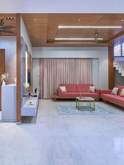 Another view of this expansive living room, showing how the different seating areas are arranged to create both a large gathering space and more intimate zones. The wood ceiling ties the entire room together.