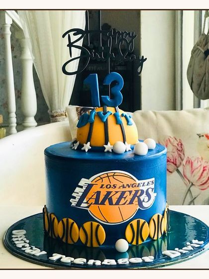 A Los Angeles Lakers themed cake for a 13th birthday, featuring the team logo and basketball details.