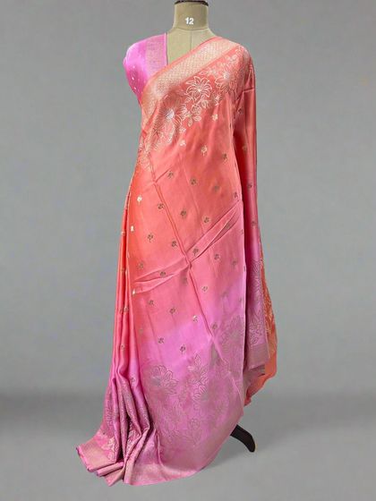 A lovely shaded satin saree in tones of peach and pink.