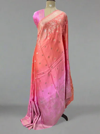 A lovely shaded satin saree in tones of peach and pink.