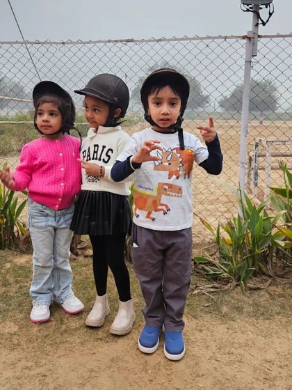 Our future riders. These three are all geared up and ready for their lesson, showing that friendship and fun are a big part of the experience.