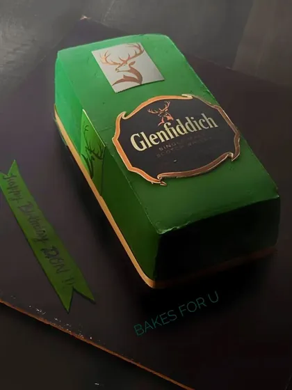 A sculpted cake designed to look exactly like a Glenfiddich single malt scotch box. This is a great example of a realistic, brand-themed cake for a whiskey aficionado.