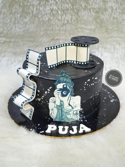 Lens focused on sweetness. This cake was designed for a photographer, featuring an edible film strip and a printed image of a photographer in action, capturing their passion in a delicious form.
