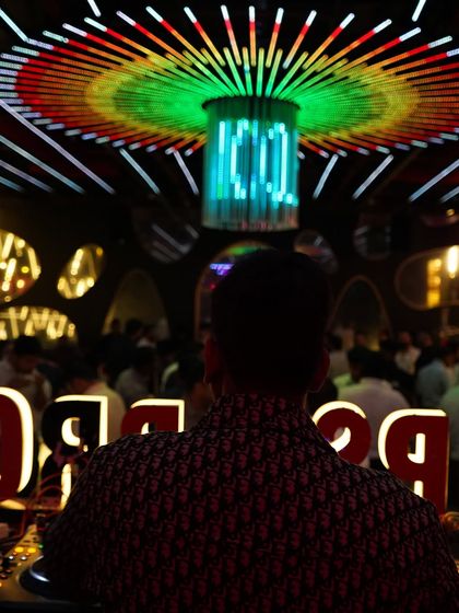 The view from my DJ booth at Tipsy Bro, with its signature lighting fixture creating an amazing visual focus. The atmosphere in this club is always electric.
