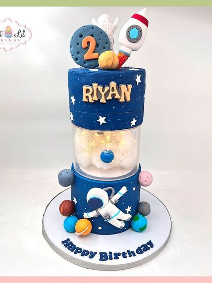 A cosmic adventure for Riyan's 2nd birthday. This tiered space cake has an astronaut, rocket, and a light-up separator tier for an extra "wow" factor.