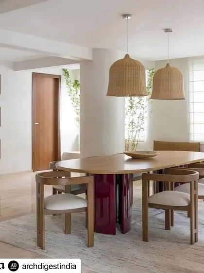A stunning dining room designed by Weespaces, featured in Architectural Digest. We crafted the unique dining table with a deep red lacquered base and solid wood top, designed to be a bold centerpiece in this earthy, minimalist space.