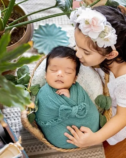 Welcoming a new baby is a special time for the whole family. I always make sure to capture the sweet bond between siblings, like this proud big sister with her new best friend.
