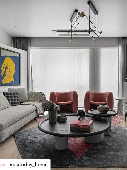Another view of the art-focused living room, as seen in India Today Home. The arrangement of furniture, including the modern armchairs and abstract lighting, is designed to facilitate both conversation and appreciation of the surrounding art pieces.