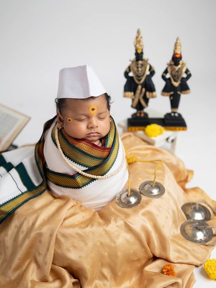 A full setup view of the little Warkari, surrounded by cymbals, idols, and a holy book, creating a complete and authentic scene.