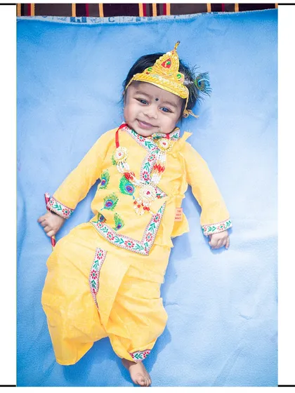 A full-length portrait of a newborn dressed as 'Little Krishna'. I ensure even my youngest subjects are safe and comfortable during these themed setups.